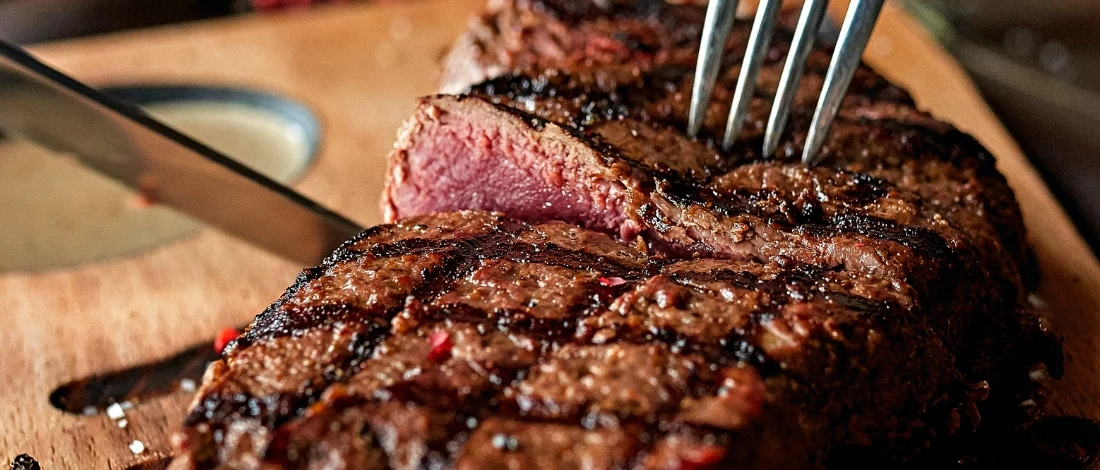 Slicing a delicious cowboy steak