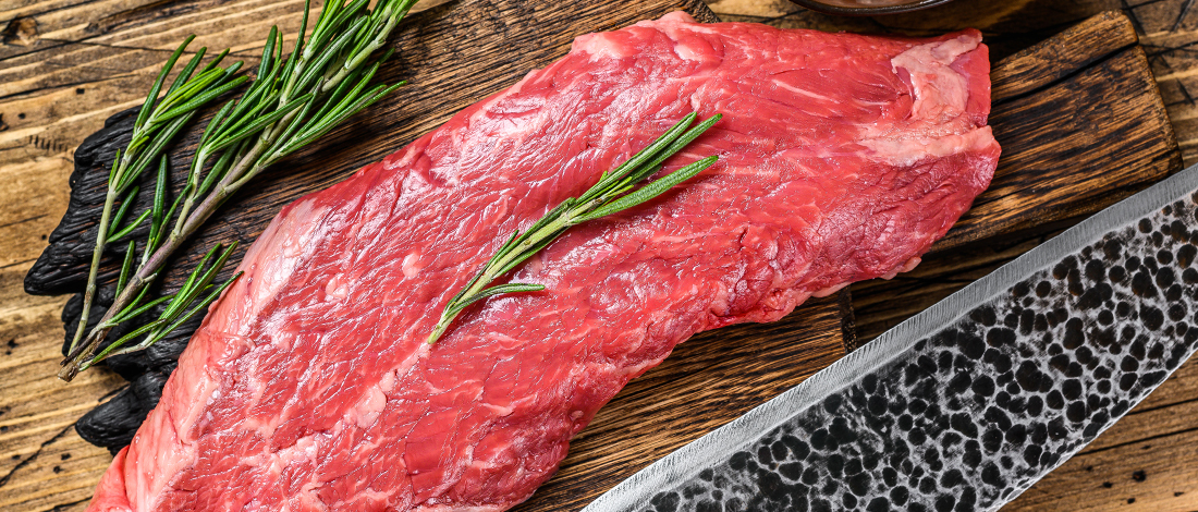 Flank Steak on wooden surface