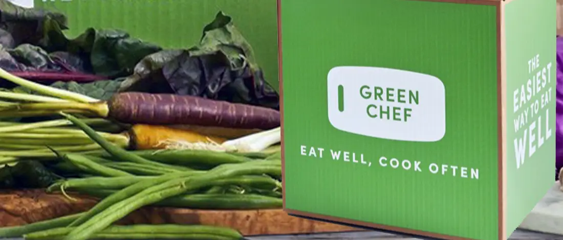 Green Chef with vegetables in the background