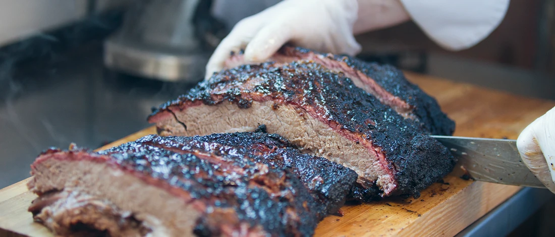 Cutting freshly smoked brisket