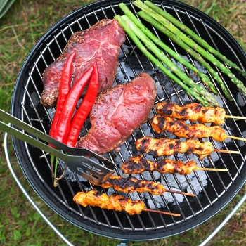 Top view of grilling food using a charcoal portable grill