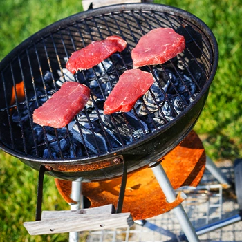 Grilling meat using a portable grill