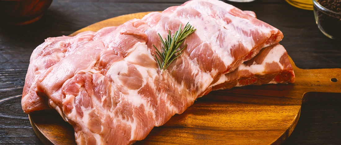 Raw ribs on wood board