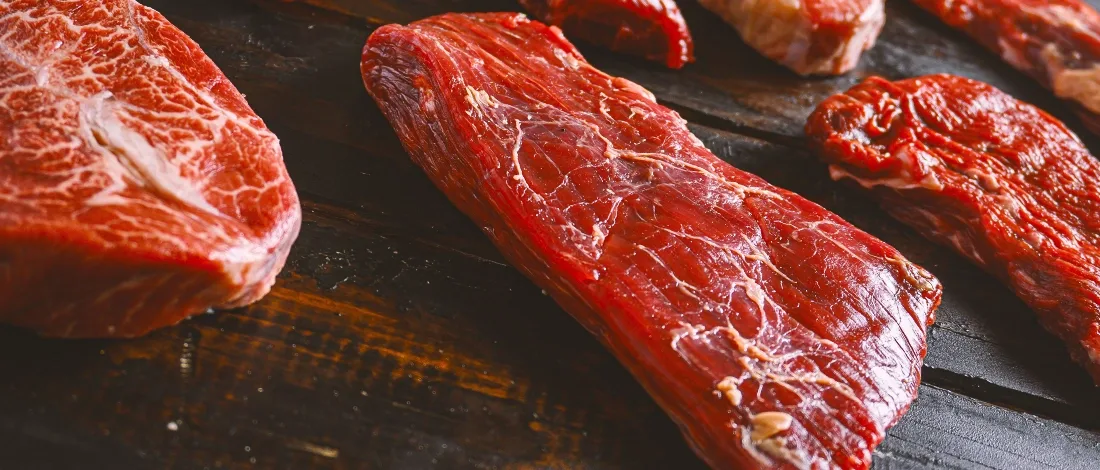 A bunch of raw steak on a table
