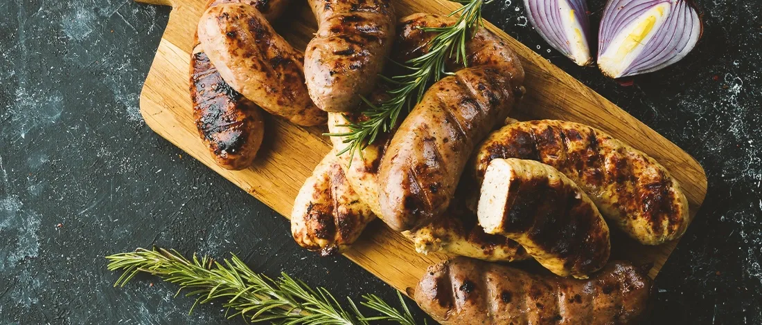Cooked sausages on a wooden board