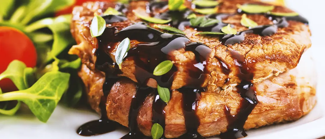 Cooked filet mignon with sauce on top