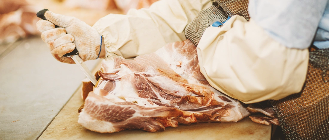 A butcher cutting up meat