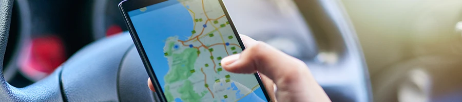A person looking at the map inside a car
