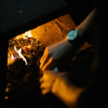 A person tending a fire