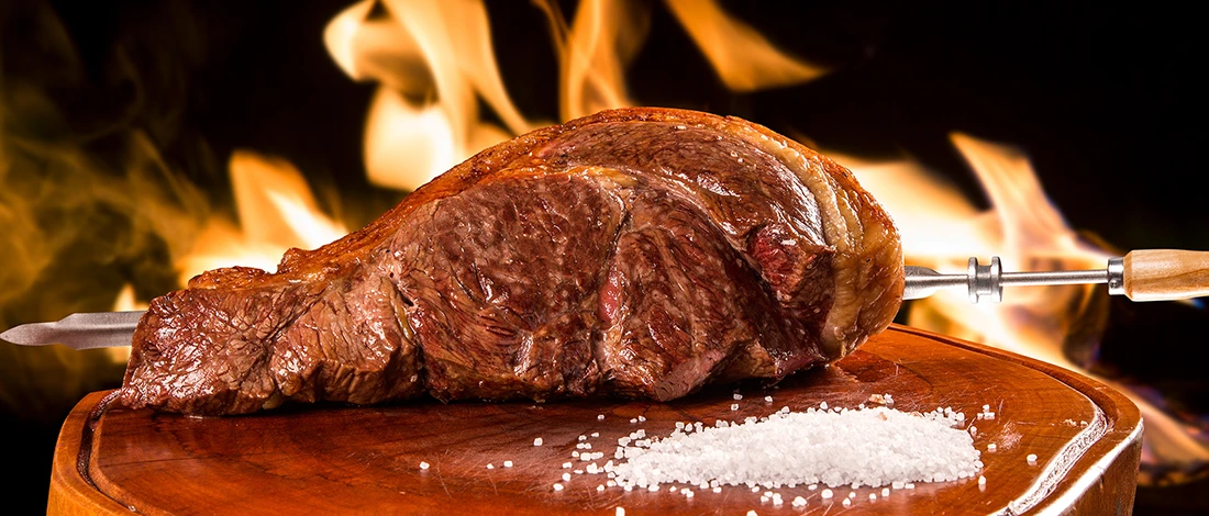 A shot of Alcatraz Brazilian beef cut with flames behind