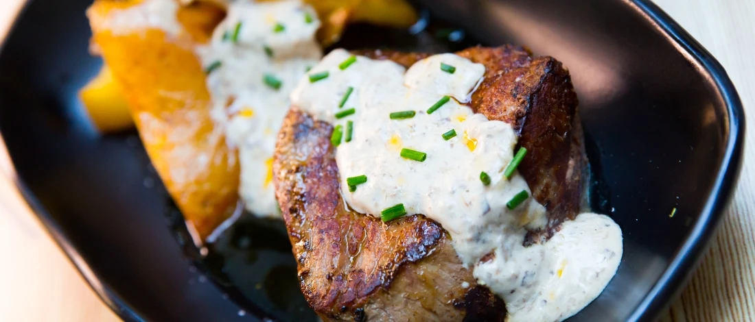 A close up shot of grilled steak marinated with yogurt