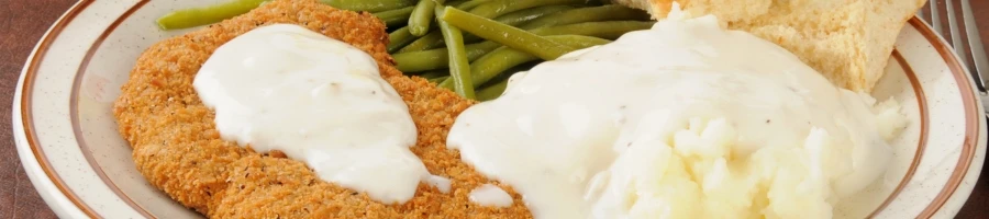A plate of delicious chicken fried steak with sides