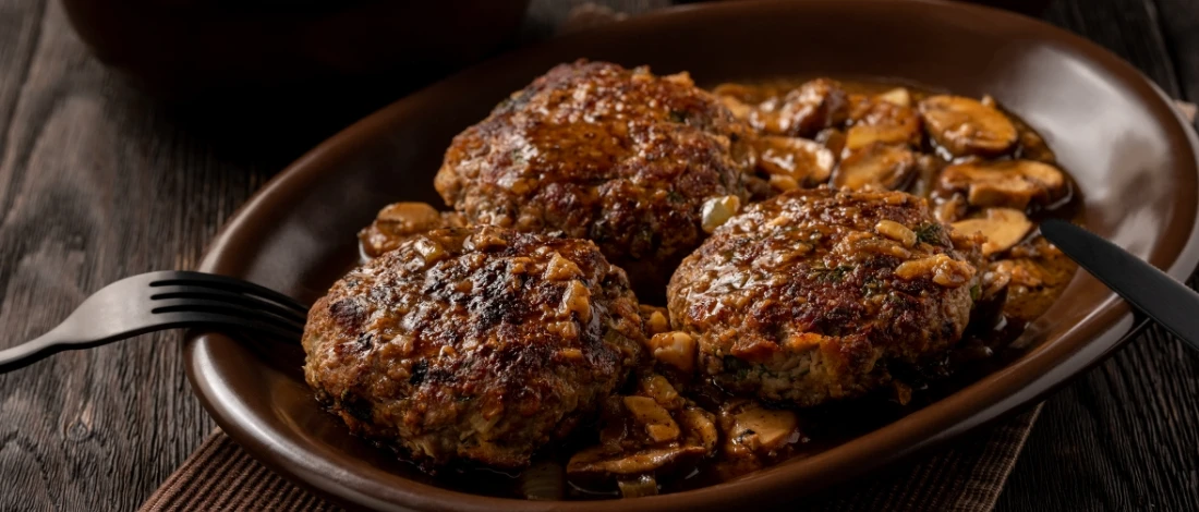 Delicious chopped beef steak with gravy and mushrooms